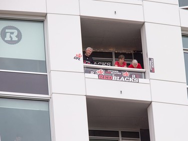 Fans of the Redblacks use signs to adorn their condo balcony that looks out over the field.