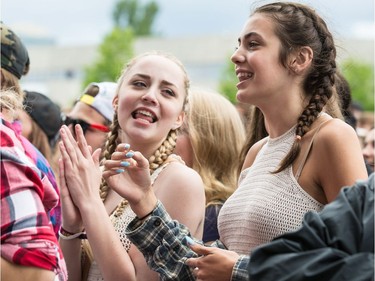 Fans singing along to Jordan McIntosh who was performing on the City Stage at Ottawa Bluesfest on Sunday July 10, 2016.