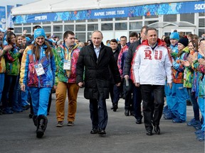 FILE - In this Feb. 5, 2014 file photo Russian President Vladimir Putin, center, visits the Olympic Athletes Village in Coastal Cluster ahead of the Sochi 2014 Winter Olympics with Olympic Village Mayor Elena Isinbaeva, left, and Russian Minister of Sport, Tourism and Youth policy Vitaly Mutko in Sochi, Russia. On Monday, July 18, 2016 WADA investigator Richard McLaren confirmed claims of state-run doping in Russia. (Pascal Le Segretain/Pool Photo via AP, file) ORG XMIT: FOS110