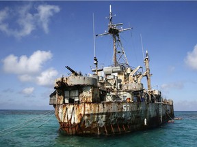 FILE - In this March 30, 2014, file photo, the dilapidated Philippine Navy ship LT 57 Sierra Madre is in the shallow waters of Second Thomas Shoal in the South China Sea. In one of the world's most disputed waters, the puny Philippine navy doesn't stand a chance against China's flotilla of combat ships. So when diplomacy went nowhere and Beijing's ships seized a disputed shoal and surrounded another reef, Filipino officials took a desperate step: They went to court.