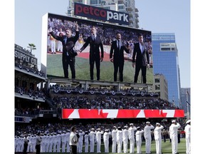 The Tenors, shown on the scoreboard, perform during the Canadian National Anthem prior to the MLB baseball All-Star Game, in San Diego. A member of a Canadian singing quartet changed a lyric in his country's national anthem and held up a sign proclaiming "All Lives Matter" during a pregame performance at the 87th All-Star Game on Tuesday. The Tenors, a group based in British Columbia, caused a stir at Petco Park with Remigio Pereira's actions while singing "O Canada."