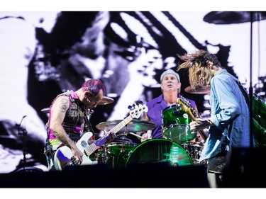 Flea, Chad Smith, and Josh Klinghoffer of the Red Hot Chili Peppers performing at Ottawa Bluesfest.