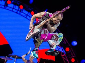 Flea of the Red Hot Chili Peppers jumps as he performs at Ottawa Bluesfest.
