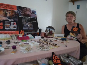 Fran Bryerton sits next to one of the tables in her kitchen where she sells jewellery to raise money for Soi Dog Foundation. (Photo by Aidan Cox/Postmedia)