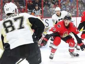Fredrik Claesson of the Ottawa Senators defends against Sidney Crosby of the Pittsburgh Penguins during second period of NHL action at Canadian Tire Centre in Ottawa, April 05, 2016.
