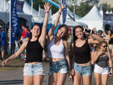 Friends Alexa Sibiga, left, Kaleigh St. Jacque, centre, and Sara Jetten, right, arrive at Ottawa Bluesfest excited to see headliner Brad Paisley.