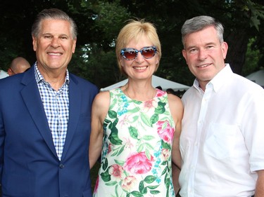 From left, Douglas McLarty and Lynn Honsberger with Grant McDonald, regional managing partner of KPMG, one of many dozens of sponsors of the U.S. Embassy's 4th of July party, held Monday, July 4, 2016, at the official residence of the U.S. ambassador in Rockcliffe Park.