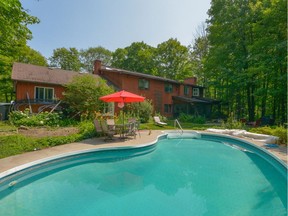 This open concept home at 1437 Huntmar Dr. includes a home office overlooking the woods and in-ground pool.