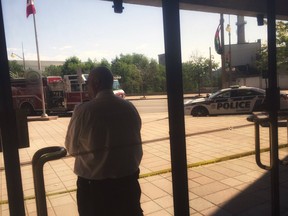 A security guard looks out of a locked down Gatineau City Hall Wednesday, July 27.