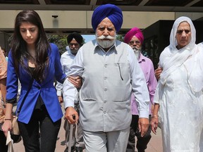An Ottawa jury found former lovers Bhupinderpal Gill and Gurpreet Ronald guilty of killing Gill's wife, Jagtar, in January 2014. Jagtar's niece, Ramandeep Chahal (blue), father Ajit Singh and mother Jagir Kaur leave the courthouse in Ottawa Wednesday after the verdict.