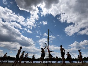 A group of friends play volleyball at Mooney's Bay Beach in Ottawa.