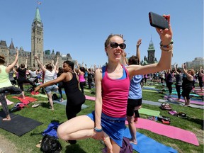 Inga Bohnekamp takes a selfie while taking part. Parliament Hill lawn was a mass of lycra as thousands took part in the first day of Parliament Hill Yoga, which runs weekly from 12 noon to 1 p.m. over the summer.