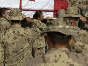 25 July 2006 Kandahar Airfield, Afghanistan Coalition Forces gather on the Airfield in Kandahar, Afghanistan, July 26, 2006 to pay their respects to Corporal Francisco Gomez, 44, Princess Patricia’s Canadian Light Infantry in Edmonton and Cpl Jason Patrick Warren, 29, a reservist with the Black Watch, Royal Highland Regiment of Canada in Montreal, are carried towards a CC-130 Hercules for Repatriation to Canada. Cpl Gomez and Cpl Warren died July 22, 2006 when a suicide bomber drove his vehicle into the back of a Bison armoured vehicle on Highway 1, 5 Km west of Kandahar, Afghanistan.