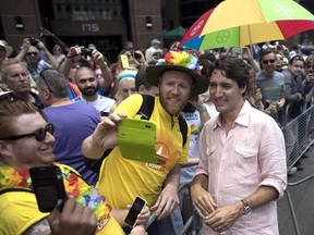 Prime Minister Justin Trudeau poses for a photo as he greets spectators at the annual Pride Parade in Toronto on Sunday, July 3, 2016.
