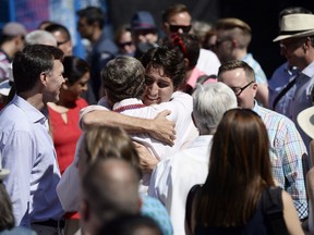 Prime Minister Justin Trudeau hugs Mayor John Tory at the annual Pride Parade in Toronto on Sunday, July 3, 2016.