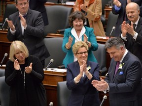 Ontario Finance Minister Charles Sousa receives applause after delivering the provincial budget from Premier Kathleen Wynne and other MPPs at Queen's Park in Toronto on Thursday, April 23, 2015.