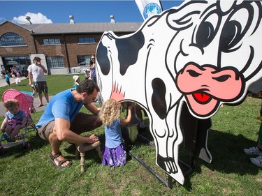 Kids learn how to milk a cow as the National Ice Cream Day is celebrated as the National Ice Cream Day is celebrated at the Ice Cream Festival taking place Sunday at the Canada Agriculture and Food Museum. Visitors to the event were given a chance to learn about the origin of milkshakes, how to make pizzelles, a traditional Italian waffle cookie, find out how much milk a cow produces each day and how much of that milk is cream, and to buy ice cream from some of Ottawa's most popular ice cream vendors such as Stella Luna and The Merry Dairy.   Wayne Cuddington/ Postmedia