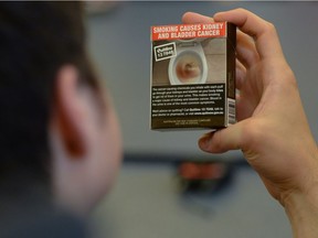 Local Ottawa high school students look at plain cigarette packaging examples, on World No Tobacco Day, prior to meeting with Minister of Health Jane Philpott in Ottawa on Tuesday, May 31, 2016. Philpott officially launched public consultations on plain packaging requirements for tobacco products.