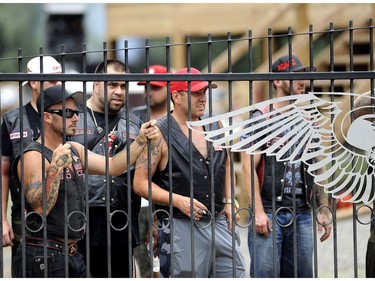 Members of a Hells Angels support club look on from inside the Hells Angels Nomads compound during the group's Canada Run event in Carlsbad Springs, Ont., near Ottawa, on Saturday, July 23, 2016.