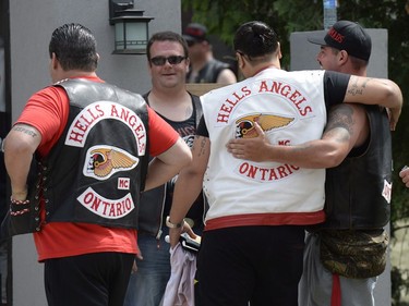 Members of the Hells Angels greet each other at the Hells Angels Nomads compound during the group's Canada Run event in Carlsbad Springs, Ont., near Ottawa, on Saturday, July 23, 2016.