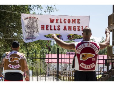 Members of the Hells Angels Nomads MC hang a welcome banner atop the gates to the clubhouse grounds in Carlsbad Springs Friday, July 22, 2016. Hundreds of bikers from across the country are descending on the sleepy hamlet for the start of their Canada Run, an annual convention of sorts.