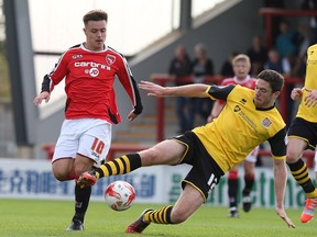 Ben Tozer of Northampton Town attempts to control the ball watched by Ryan Williams of Morecambe during the Sky Bet League Two match between Morecambe and Northampton Town at Globe Arena on September 27, 2014 in Morecambe, England.