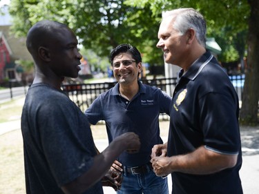 MPP Yasir Naqvi, centre, and police Chief Charles Bordeleau, right, chat with a member of the community at the 11th annual Naqvi Cup.