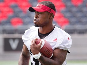 Nic Grigsby carries the ball as the Ottawa Redblacks run a walk through practice in advance of their CFL game against the Calgary Stampeders on Friday night.  Wayne Cuddington/ Postmedia