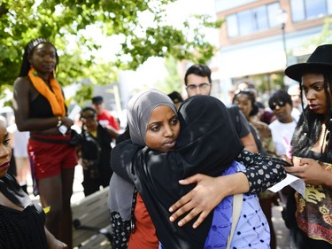 One of the demonstrators share hug with a member from Abdi family at  March for Justice - In Memory of Abdirahman Abdi. Saturday, July 30, 2016.