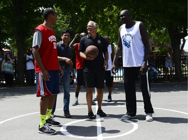 Ottawa police Chief Charles Bordeleau takes part in the ceremonial tip-off to begin the game between the St. Luke's Bulls and members from Ottawa Police Service at the 11th annual Naqvi Cup.