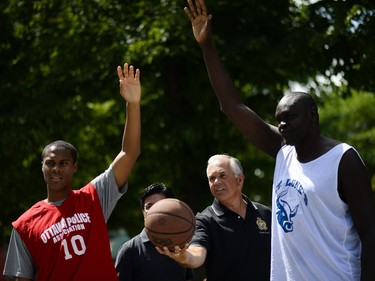 Ottawa police Chief Charles Bordeleau takes part in the ceremonial tip-off to begin the game between the St. Luke's Bulls and members from Ottawa Police Service at the 11th annual Naqvi Cup.