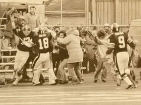 Tony Gabriel of Ottawa is mobbed by fellow players and fans after scoring the winning touchhdown in the dying moments of the 1976 Grey Cup game.