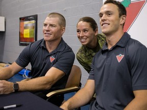 Ottawa Senators Chris Neil (L) and Chicago Blackhawks captain Jonathan Toews  with Private Anita Simoneau during their visit to CFB Leitrim where they kicked-off a partnership between Canadian Tire and the Canadian Forces Morale and Welfare services to supply money and sporting equipment to help military families living on base to get active. Monday July 18, 2016.