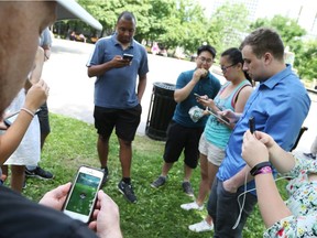 Patrick Albert (L) and many gamers showed up at Confederation Park in Ottawa to play Pokemon Go, July 12, 2016. Photo by Jean Levac