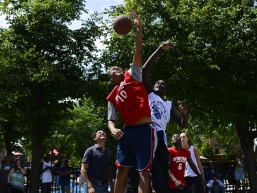 Players from the St. Luke's Bulls and the Ottawa Police Service jump for the ball after the ceremonial tip-off by Ottawa police Chief Charle Bordeleau at 11th annual Naqvi Cup.