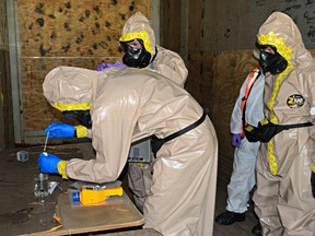 Members of the U.S. Army 11th Chemical Company (CBRNE) collect a sample for analysis during Exercise Precise Response at the Canadian Forces Base Suffield in Alberta, Canada from July 11 to 29. Missions throughout the exercise included assessing hazards in multiple compounds, mitigating explosive threats and collecting samples for analysis.