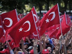 Pro-government wave Turkish flags as they protest the attempted coup, in Istanbul. The Turkish government has accelerated and widened its crackdown on alleged plotters of the failed coup against President Recep Tayyip Erdogan.