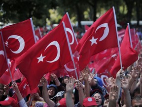 Pro-government wave Turkish flags as they protest against the attempted coup, in Istanbul, Tuesday, July 19, 2016. The Turkish government accelerated its crackdown on alleged plotters of the failed coup against President Recep Tayyip Erdogan.