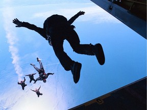 Canadian military parachutists jump from a Buffalo aircraft in this file photo. Province Photo by Peter Blashill)