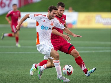 Railhawks player Steven Miller, left, and Thomas Stewart battle for the ball in the first half.