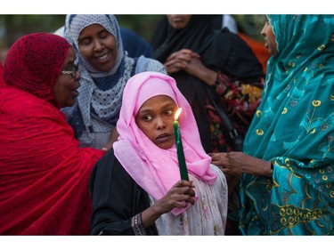 Riyad Ali and other women gather together as a vigil  takes place for Abdirahman Abdi, 37, who passed away from injuries he suffered on Sunday during a confrontation with Ottawa Police.   Wayne Cuddington/ Postmedia