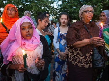 Riyad Ali (left) and other women gather together as a vigil  takes place for Abdirahman Abdi, 37, who passed away from injuries he suffered on Sunday during a confrontation with Ottawa Police.   Wayne Cuddington/ Postmedia