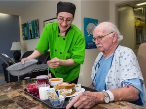 Rose Bann brings patient Pat Slatter, 67, his lunch at the Queensway Carleton Hospital. The food, Slatter says, is 'better than at the Château Laurier.'