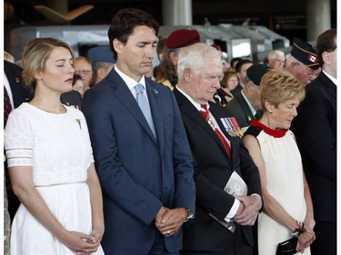 Heritage Minister Melanie Joly, left to right, Prime Minister Justin Trudeau, Governor General David Johnston and his wife Sharon, bow their heads for a moment of silence in commemoration of the 100th anniversary of the Battles of the Somme and Beaumont-Hamel, at the National War Museum in Ottawa, Friday, July 1, 2016.