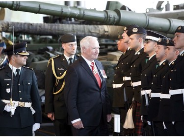 Governor General David Johnston inspects the Honor Guard during a ceremony to commemorate the 100th anniversary of the Battles of the Somme and Beaumont-Hamel, at the National War Museum in Ottawa, Friday, July 1, 2016.