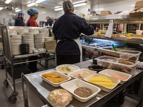 Staff at the General Campus of the Ottawa Hospital prepare food trays for patients. (Photo: Errol McGihon/Postmedia)