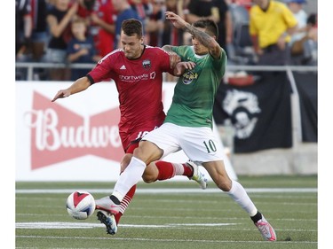 The Ottawa Fury's Thomas Stewart, left, and the Tampa Bay Rowdies' Georgi Hristov chase the ball during the first half.