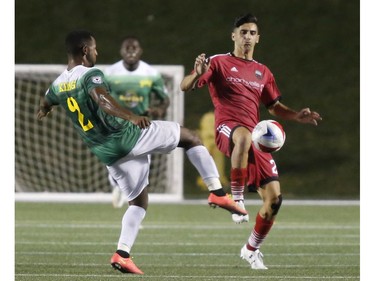 The Tampa Bay Rowdies' Darnell King, left, and the Ottawa Fury's Mauro Eustaquio both try to kick the ball during the second half.