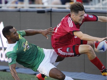 The Tampa Bay Rowdies' Darnell King, left, and the Ottawa Fury's Maxim Tissot collide during the first half.