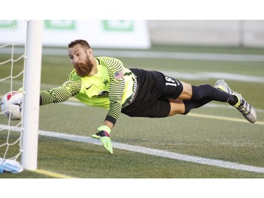The Tampa Bay Rowdies goalkeeper Matt Pickens dives for the ball as Ottawa Fury FC scores its second goal.